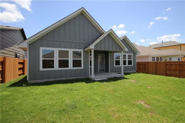 a view of a house with a yard and sitting area