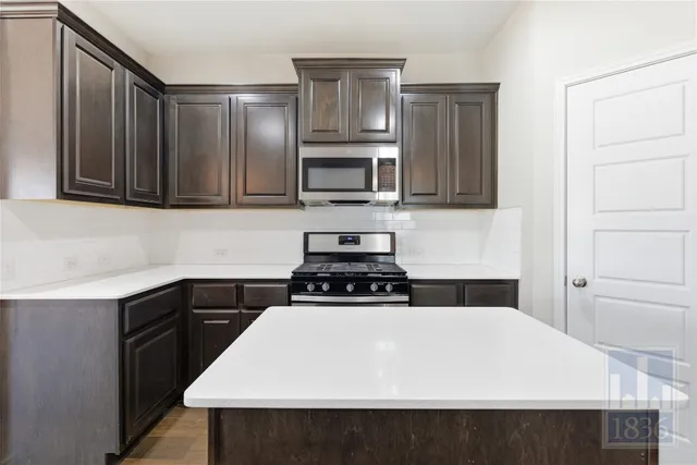 a kitchen with a stove and a microwave