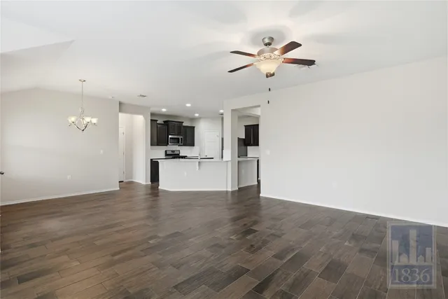 a view of a kitchen with a sink and a refrigerator