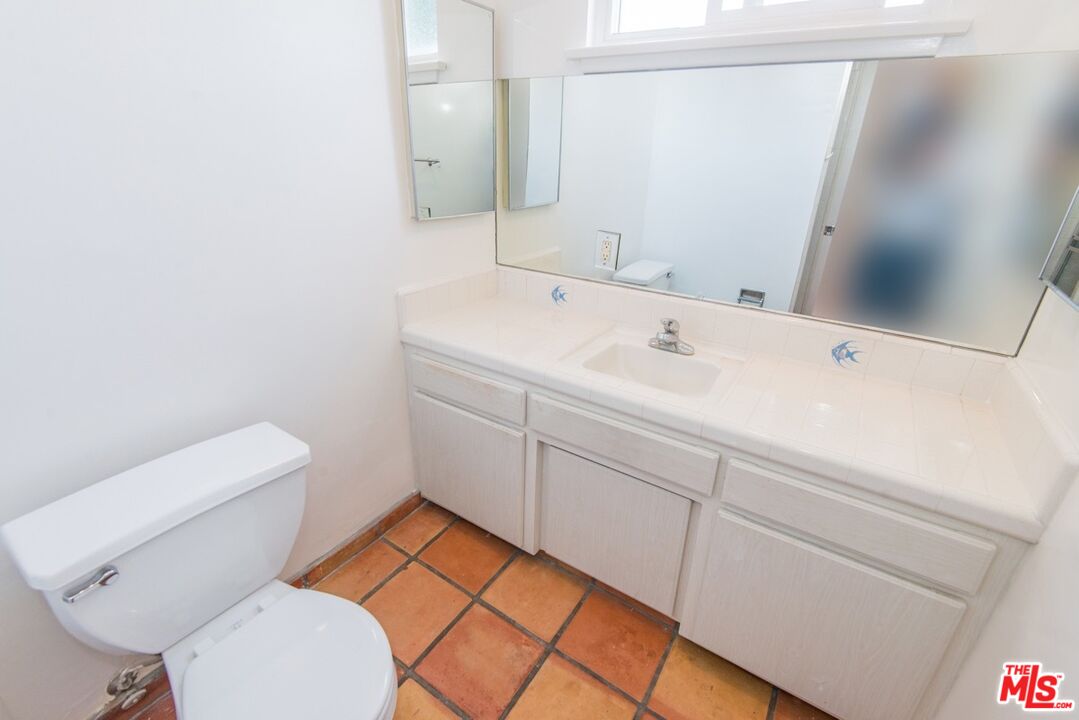 8531 Walnut Drive Los Angeles, CA 90046 - Photo 11 of 17 a bathroom with a toilet sink and mirror