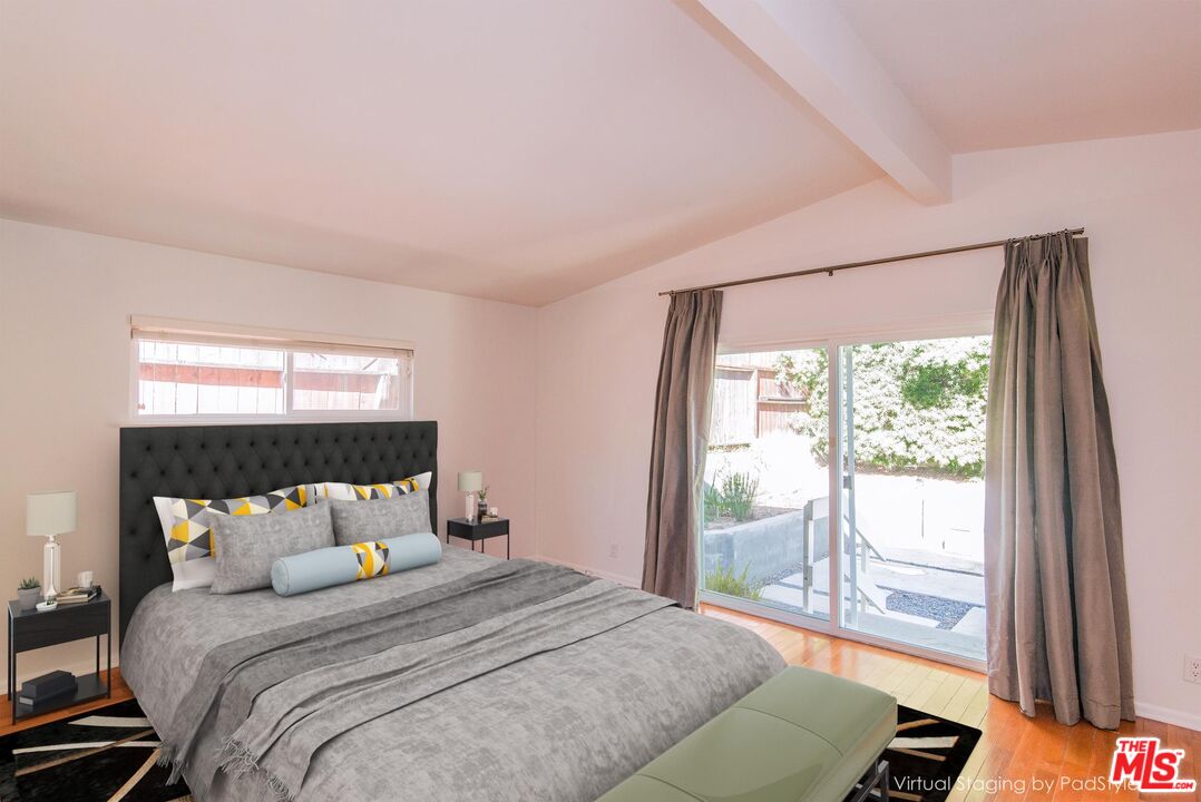8531 Walnut Drive Los Angeles, CA 90046 - Photo 12 of 17 a bed sitting in a bedroom next to a window