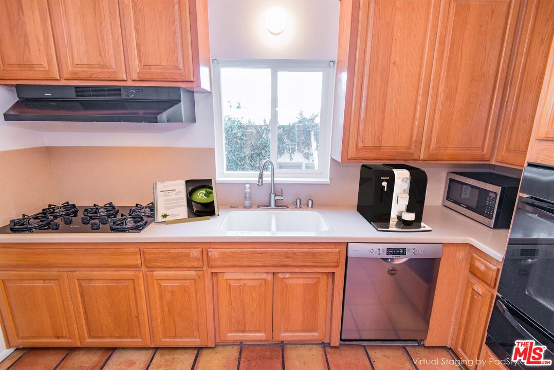 8531 Walnut Drive Los Angeles, CA 90046 - Photo 7 of 17 a kitchen with stainless steel appliances a stove a sink a counter space and cabinets