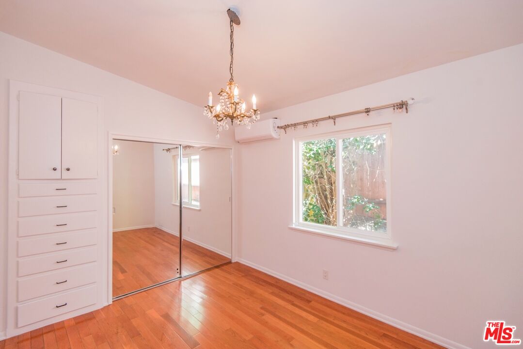 8531 Walnut Drive Los Angeles, CA 90046 - Photo 10 of 17 a view of a livingroom with a chandelier fan and windows