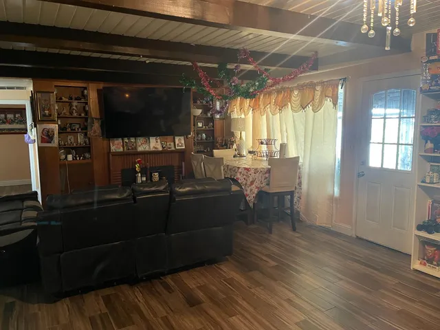 a room with wooden floor and furniture