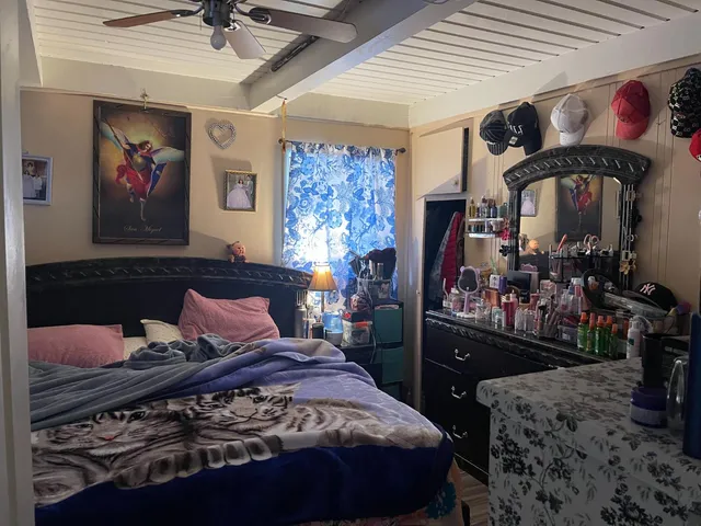 a bedroom with a bed and a dresser