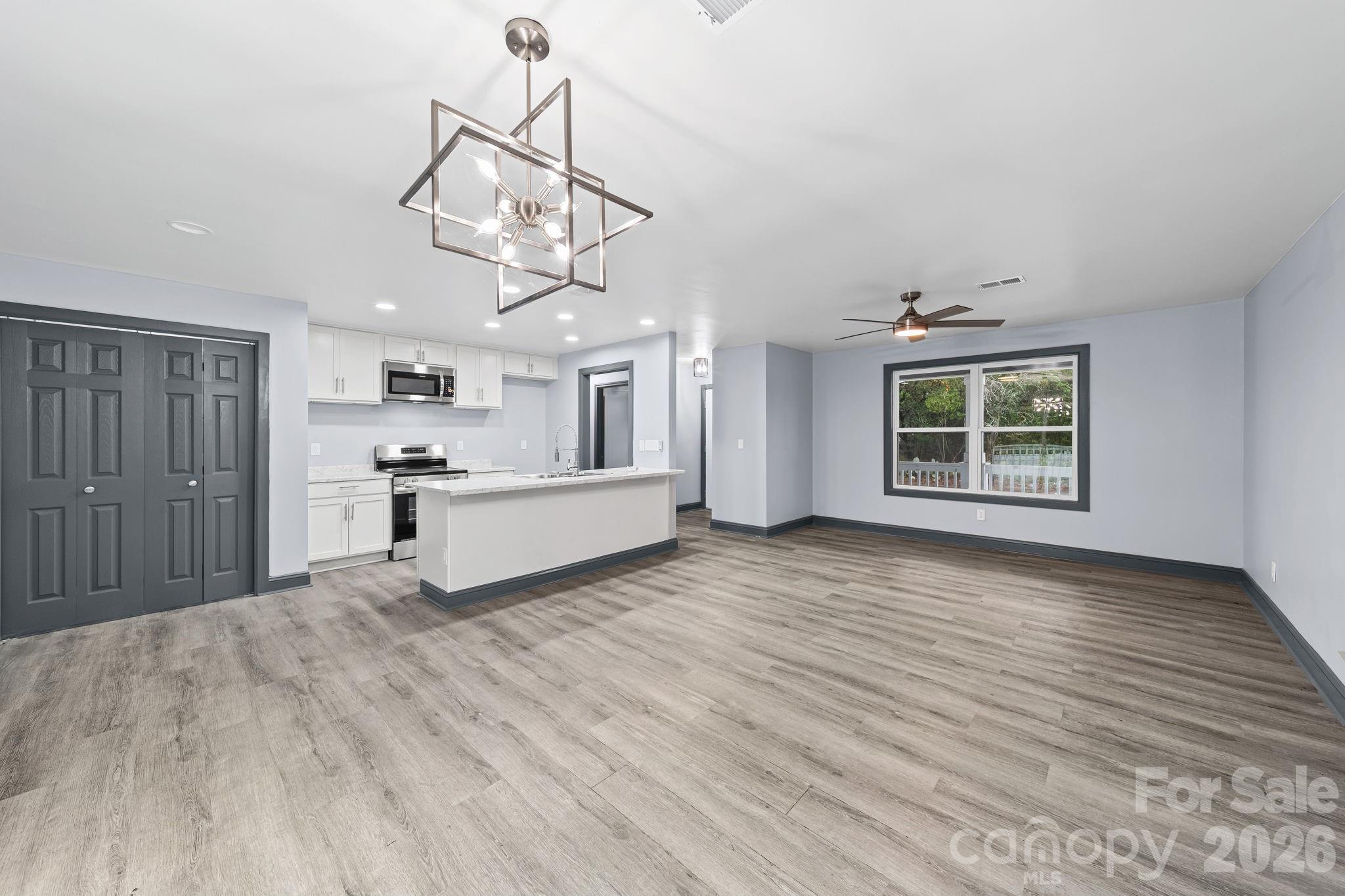 109 Haddock Road Northwest Orangeburg, SC 29115 - Photo 19 of 48 a view of a kitchen with wooden floor and a ceiling fan