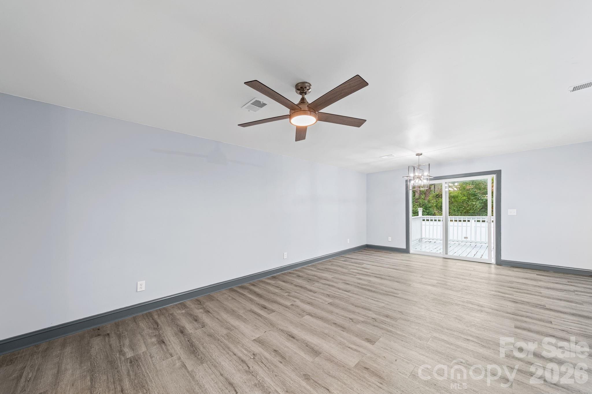 109 Haddock Road Northwest Orangeburg, SC 29115 - Photo 23 of 48 an empty room with wooden floor and windows