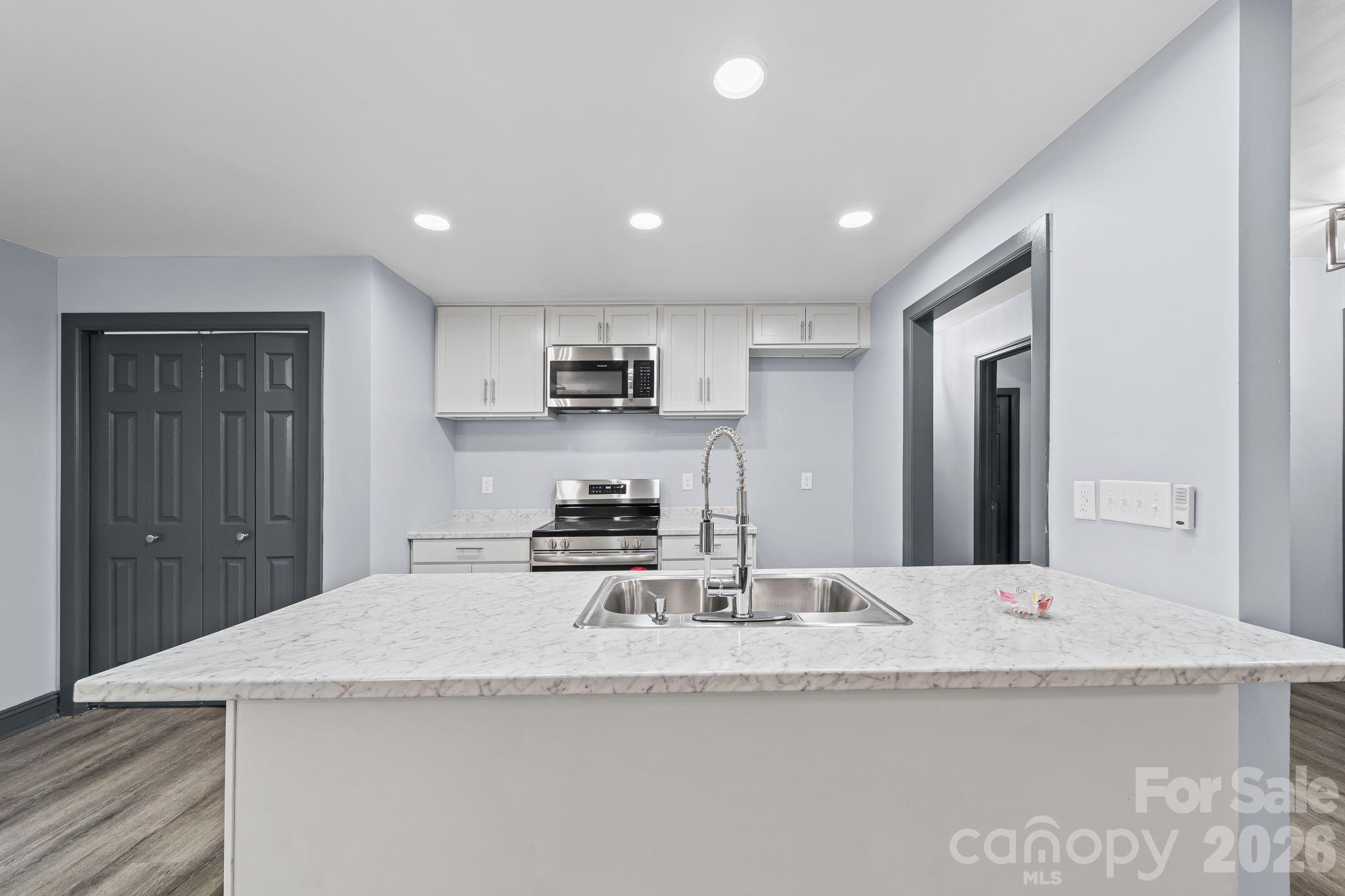 109 Haddock Road Northwest Orangeburg, SC 29115 - Photo 24 of 48 a kitchen with granite countertop kitchen island stainless steel appliances a sink a stove a refrigerator a sink and a refrigerator