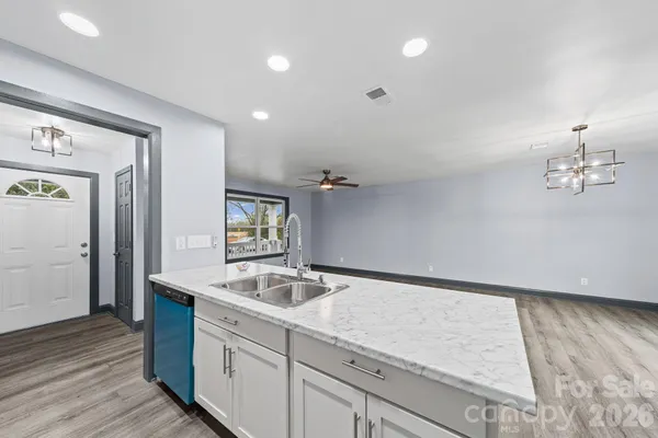 a spacious bathroom with a sink and a mirror