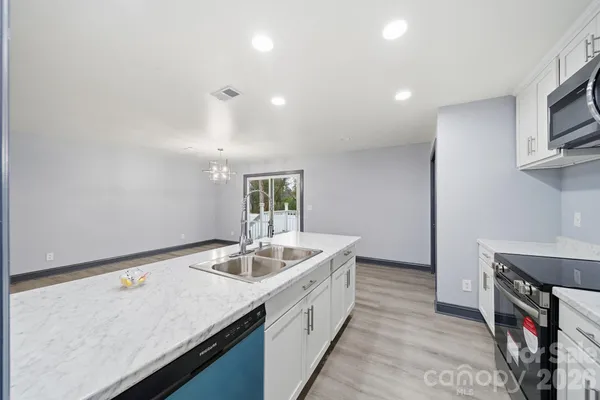 a utility room with cabinets washer and dryer