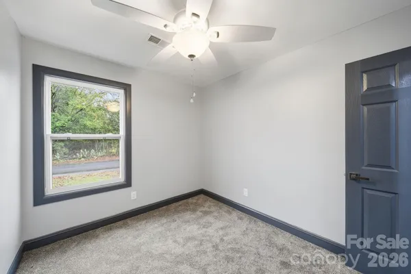 an empty room with a ceiling fan