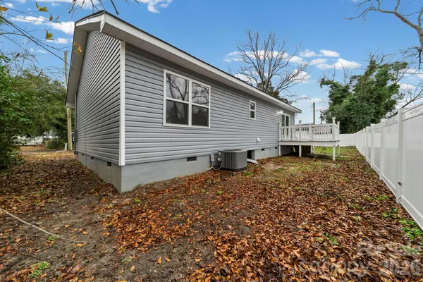 a view of a house with a yard and deck