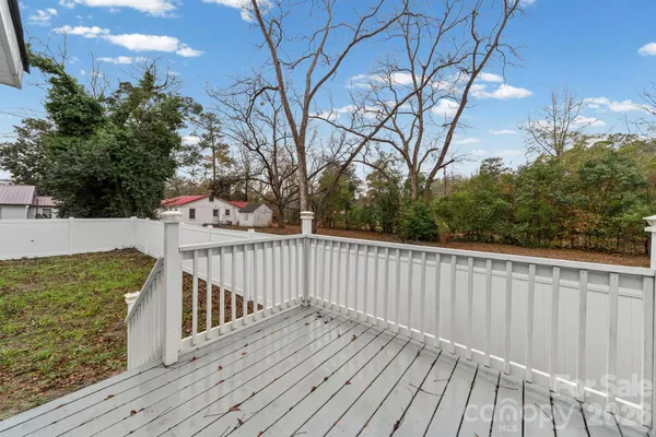 a view of a balcony with wooden floor and fence