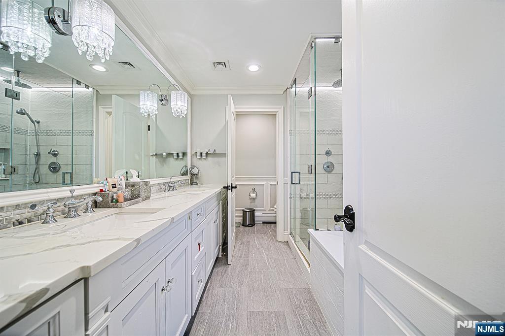 897 Virgil Avenue Ridgefield, NJ 07657 - Photo 35 of 50 a spacious bathroom with a double vanity sink a mirror and shower