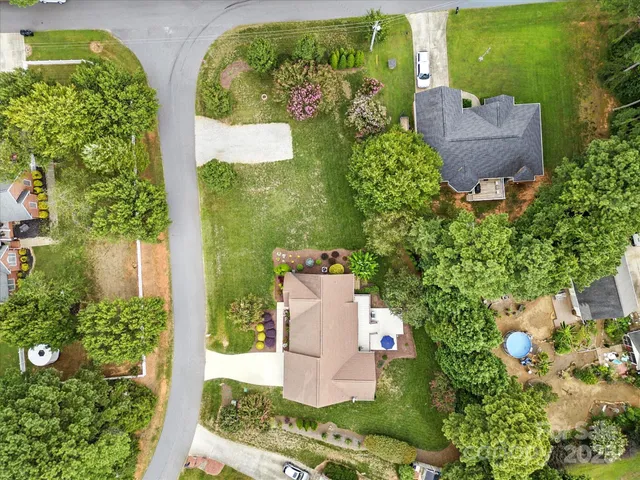 an aerial view of a house with a yard and garden
