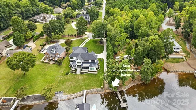 a backyard of a house with a yard and outdoor seating