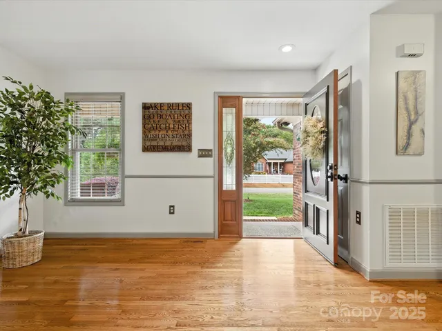 a view of a livingroom with wooden floor and a large window