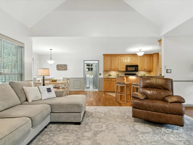 a living room with furniture and kitchen view