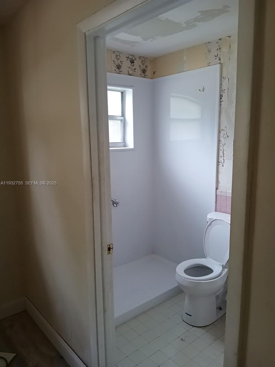 10210 Southwest 175th Street Miami, FL 33157 - Photo 12 of 14 a white toilet sitting next to a bathroom sink