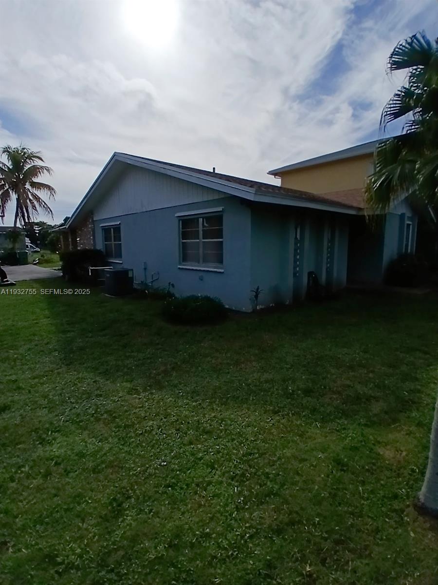 10210 Southwest 175th Street Miami, FL 33157 - Photo 2 of 14 a house with green field in front of it