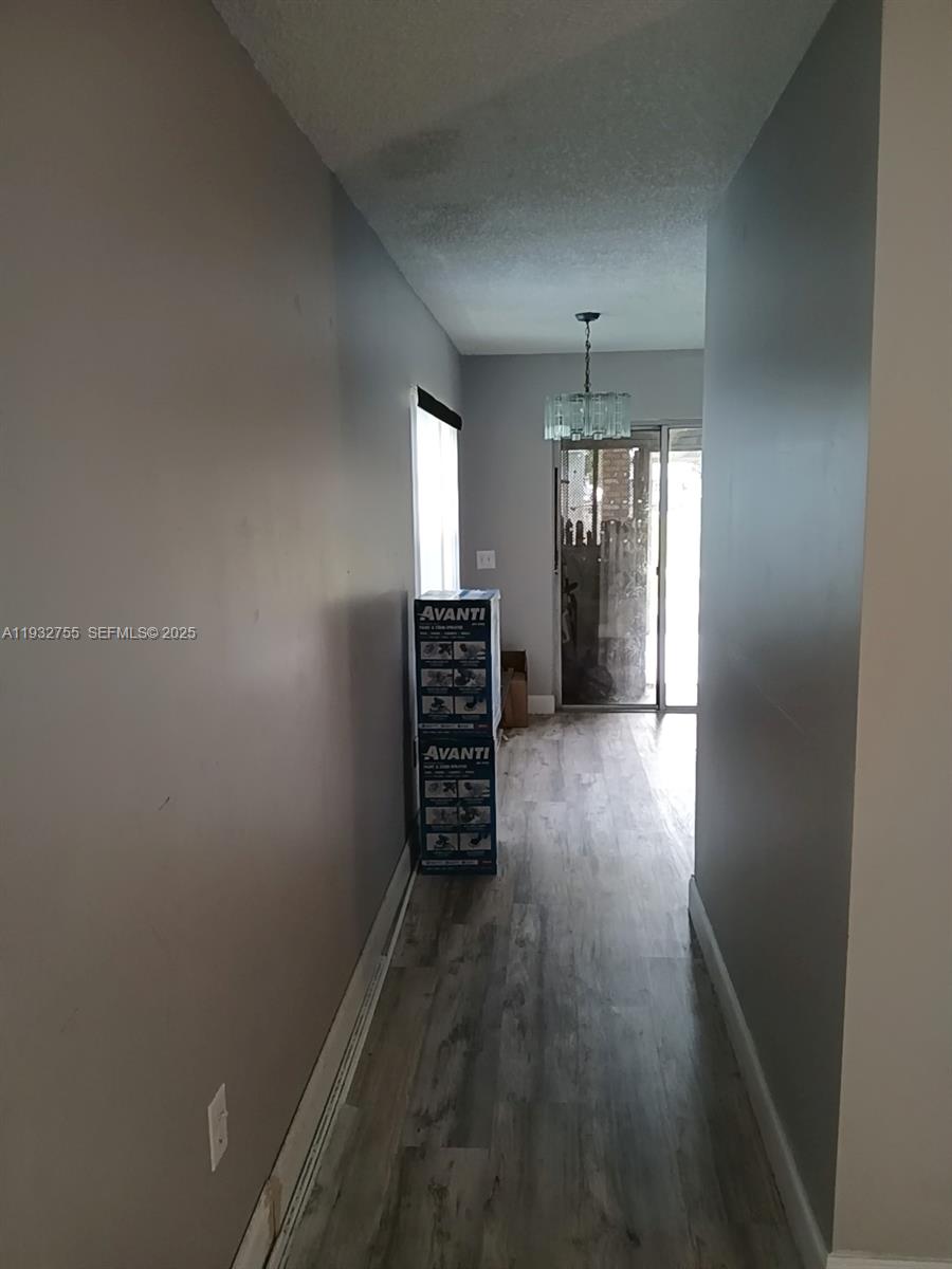 10210 Southwest 175th Street Miami, FL 33157 - Photo 6 of 14 wooden floor in an empty room with a window