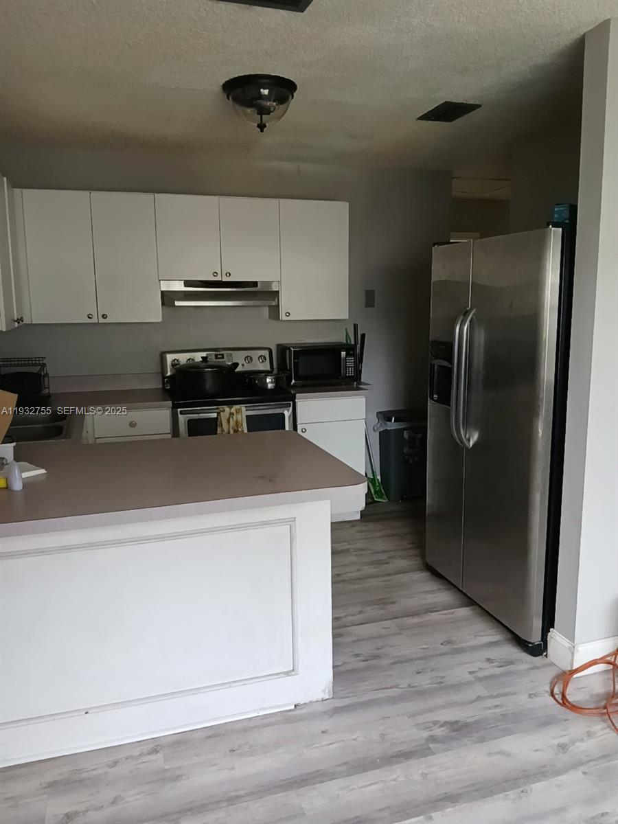 10210 Southwest 175th Street Miami, FL 33157 - Photo 7 of 14 a kitchen with a refrigerator and a sink