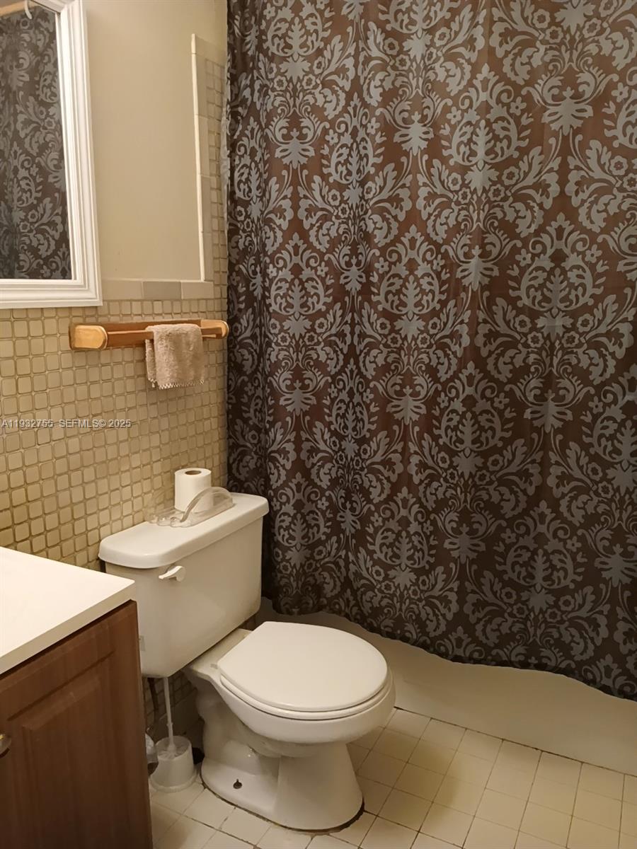 10210 Southwest 175th Street Miami, FL 33157 - Photo 8 of 14 a bathroom with a toilet and a sink