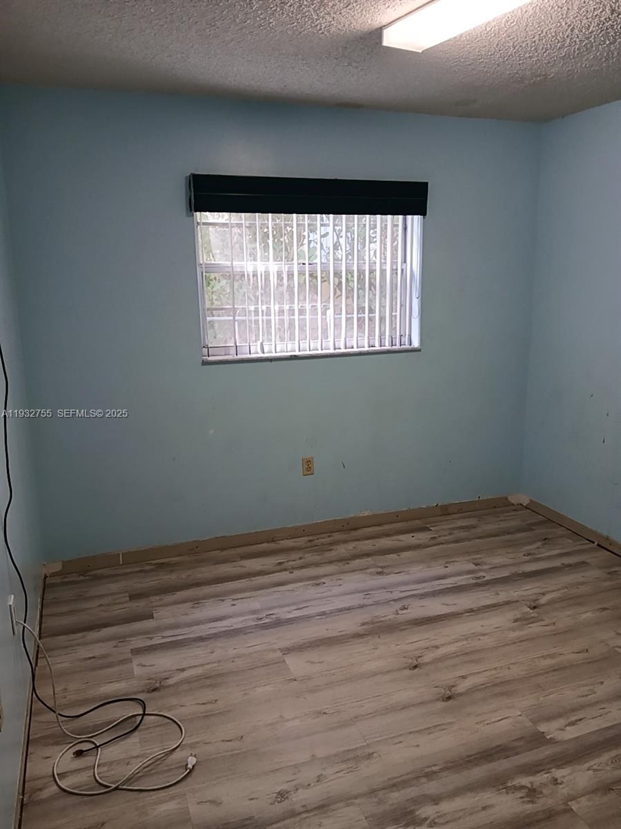 10210 Southwest 175th Street Miami, FL 33157 - Photo 9 of 14 a view of a small space with wooden floor and a window