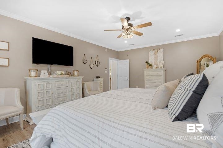 24541 Baldwin Beach Expressway Robertsdale, AL 36567 - Photo 16 of 51 Bedroom with baseboards, ornamental molding, and light wood-style flooring