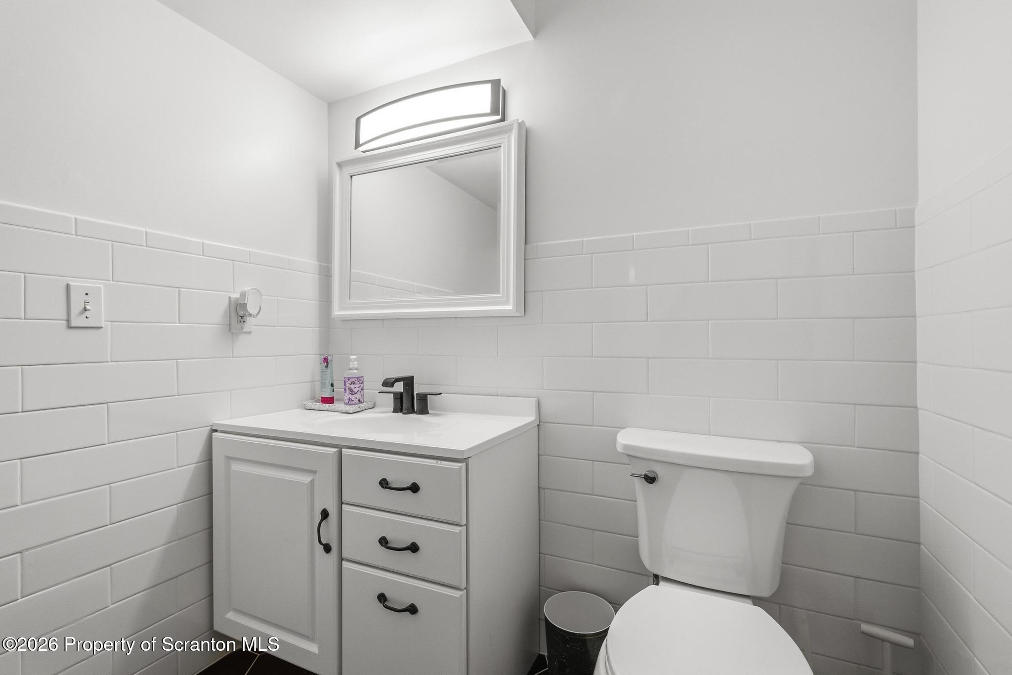 58 Bender Road Gouldsboro, PA 18424 - Photo 36 of 55 a bathroom with a toilet sink vanity and mirror