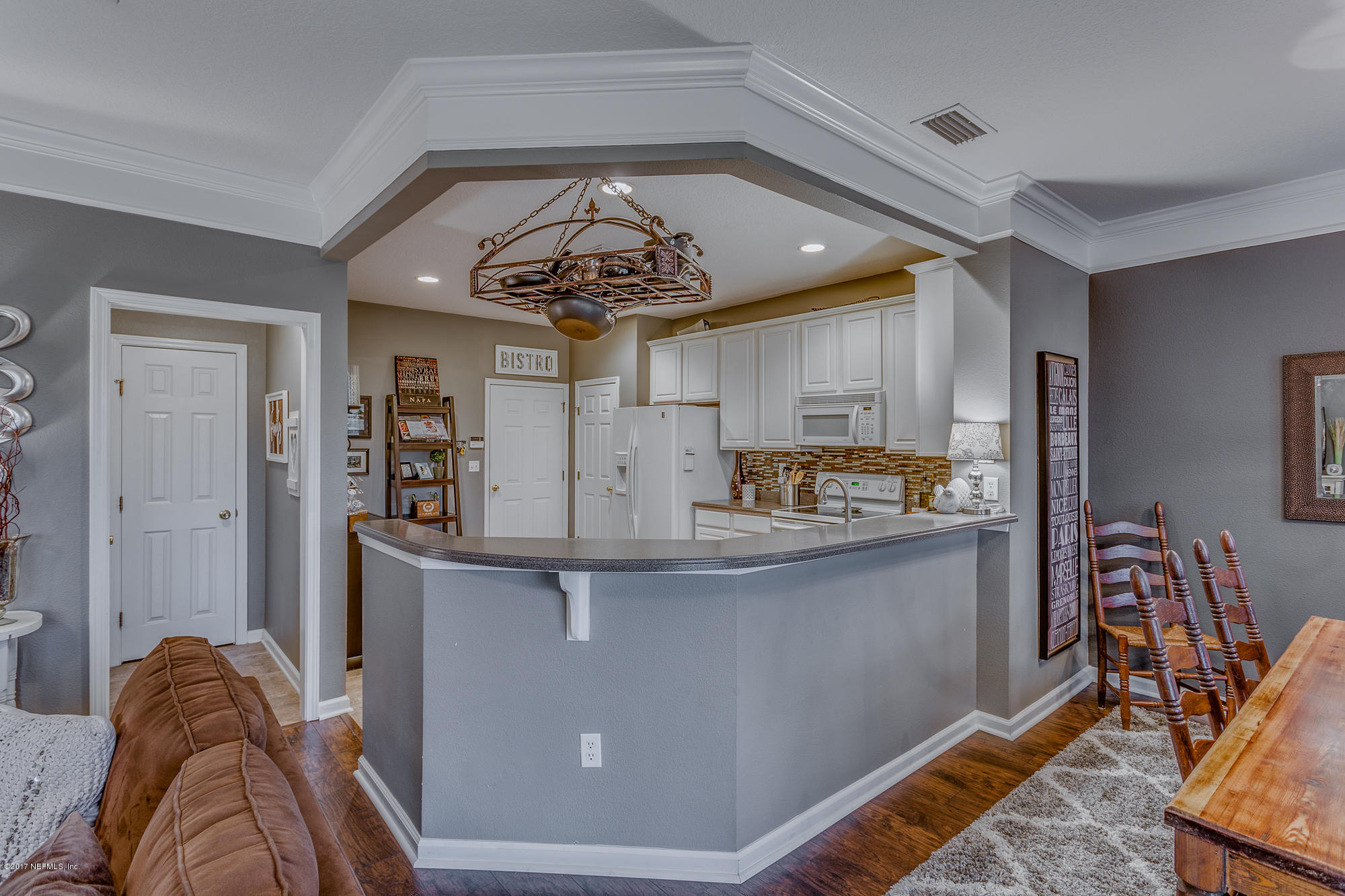 11113 Fallgate Point Court Jacksonville, FL 32256 - Photo 27 of 49 a view of a kitchen with kitchen island stainless steel appliances refrigerator stove and wooden floor