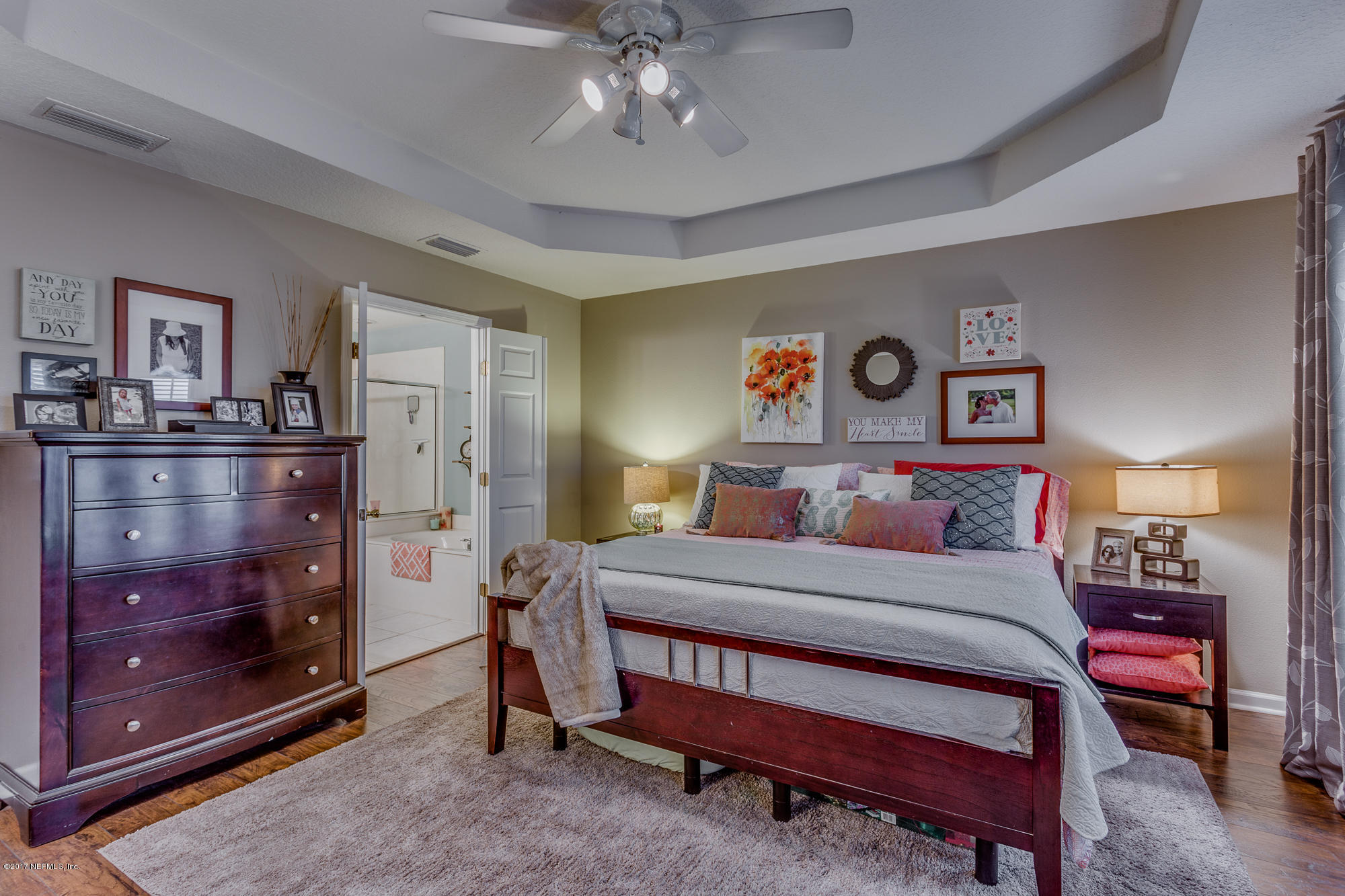 11113 Fallgate Point Court Jacksonville, FL 32256 - Photo 34 of 49 a bedroom with a bed and a chandelier