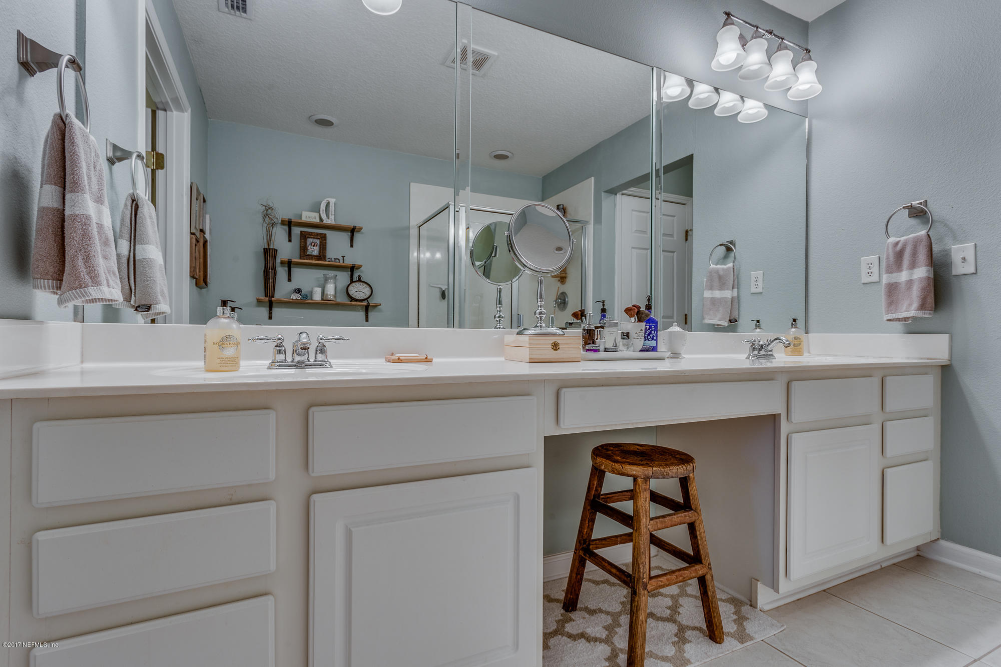 11113 Fallgate Point Court Jacksonville, FL 32256 - Photo 39 of 49 a bathroom with a sink vanity and a mirror