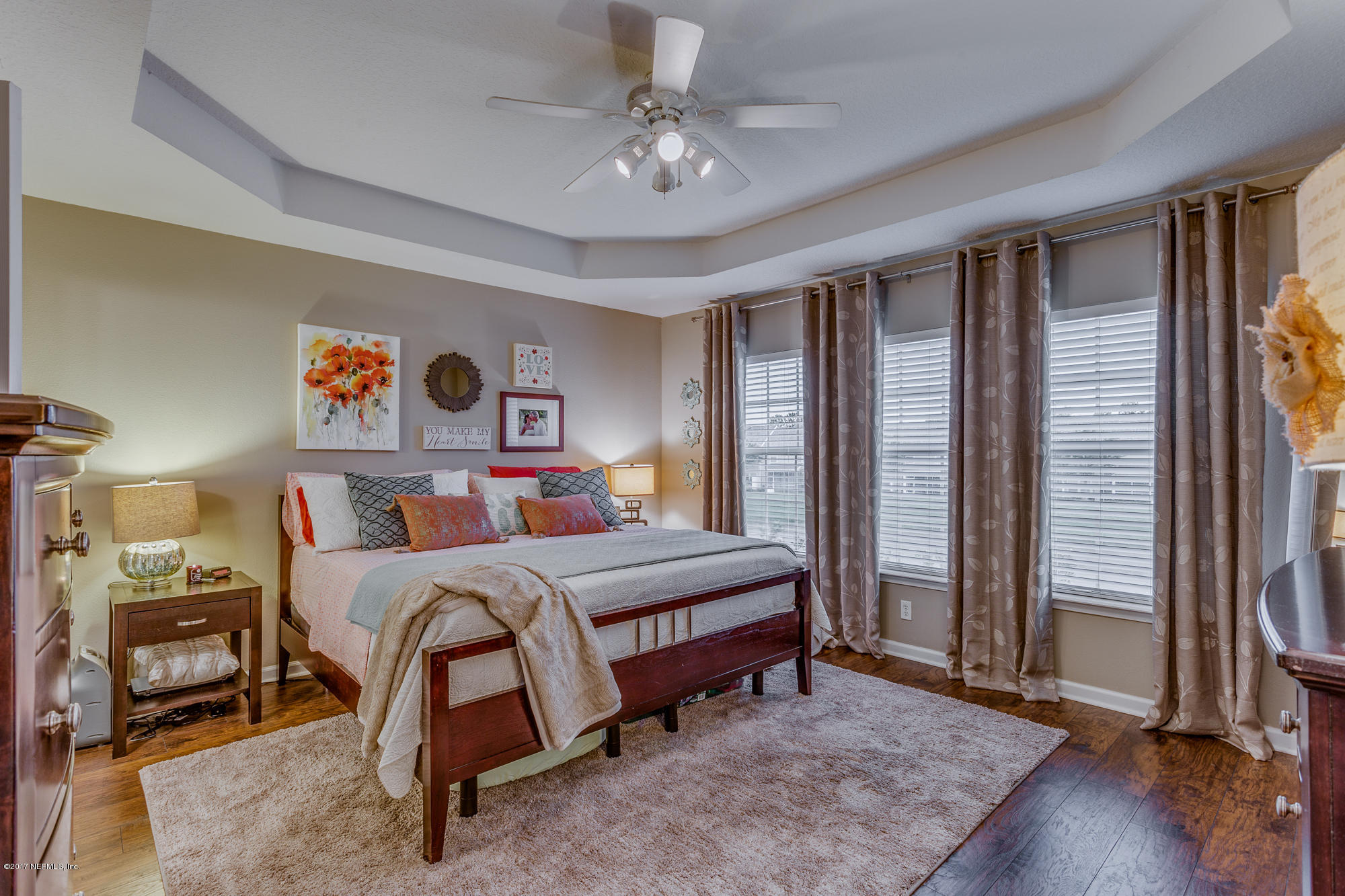 11113 Fallgate Point Court Jacksonville, FL 32256 - Photo 42 of 49 a bedroom with a bed and a chandelier