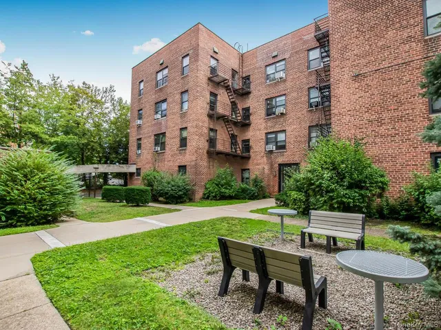 a view of a chairs and table in backyard of the house