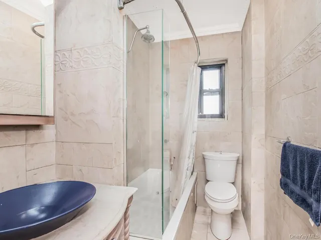 a bathroom with a toilet a sink and shower