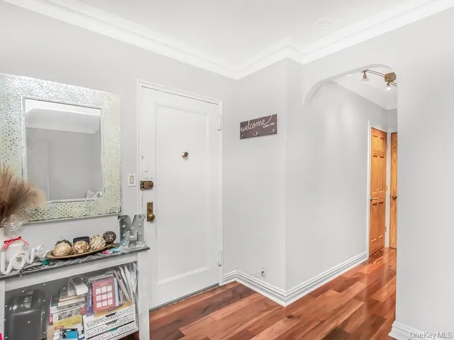 a room with a mirror and a wooden floor