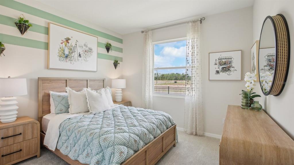 17542 Maple Grv Road Land O Lakes, FL 34638 - Photo 19 of 34 a bedroom with a bed and a painting on the wall