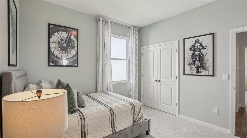 17542 Maple Grv Road Land O Lakes, FL 34638 - Photo 23 of 34 a bedroom with a bed and a painting on the wall