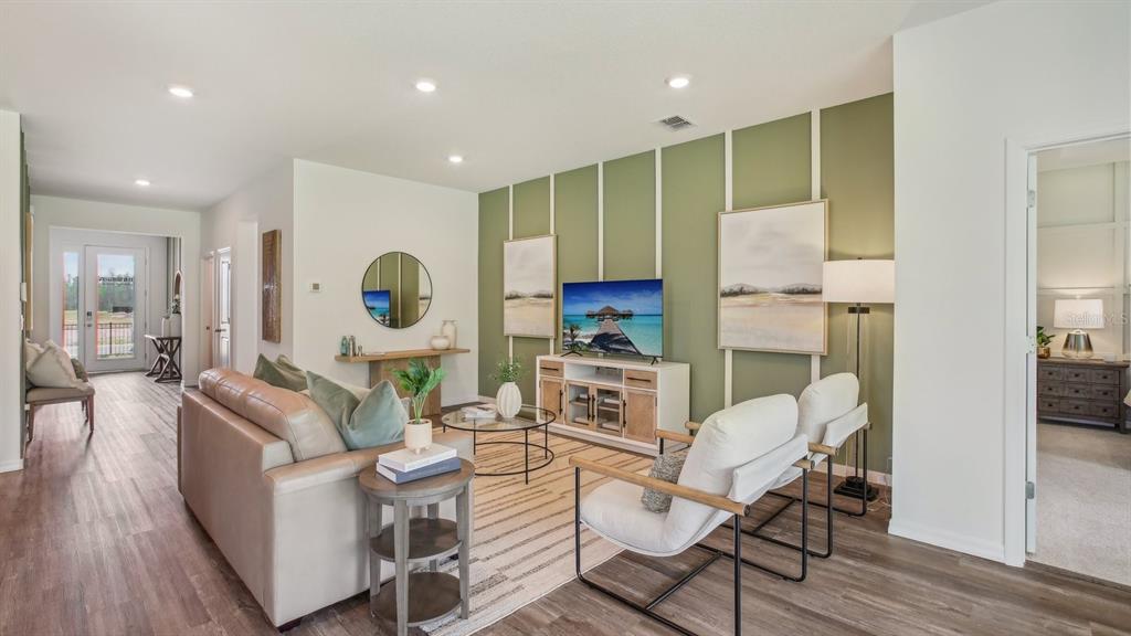 17542 Maple Grv Road Land O Lakes, FL 34638 - Photo 3 of 34 a living room with fireplace furniture and a wooden floor