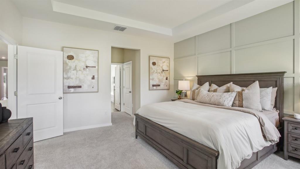 17542 Maple Grv Road Land O Lakes, FL 34638 - Photo 33 of 34 a bedroom with bed and walk in closet