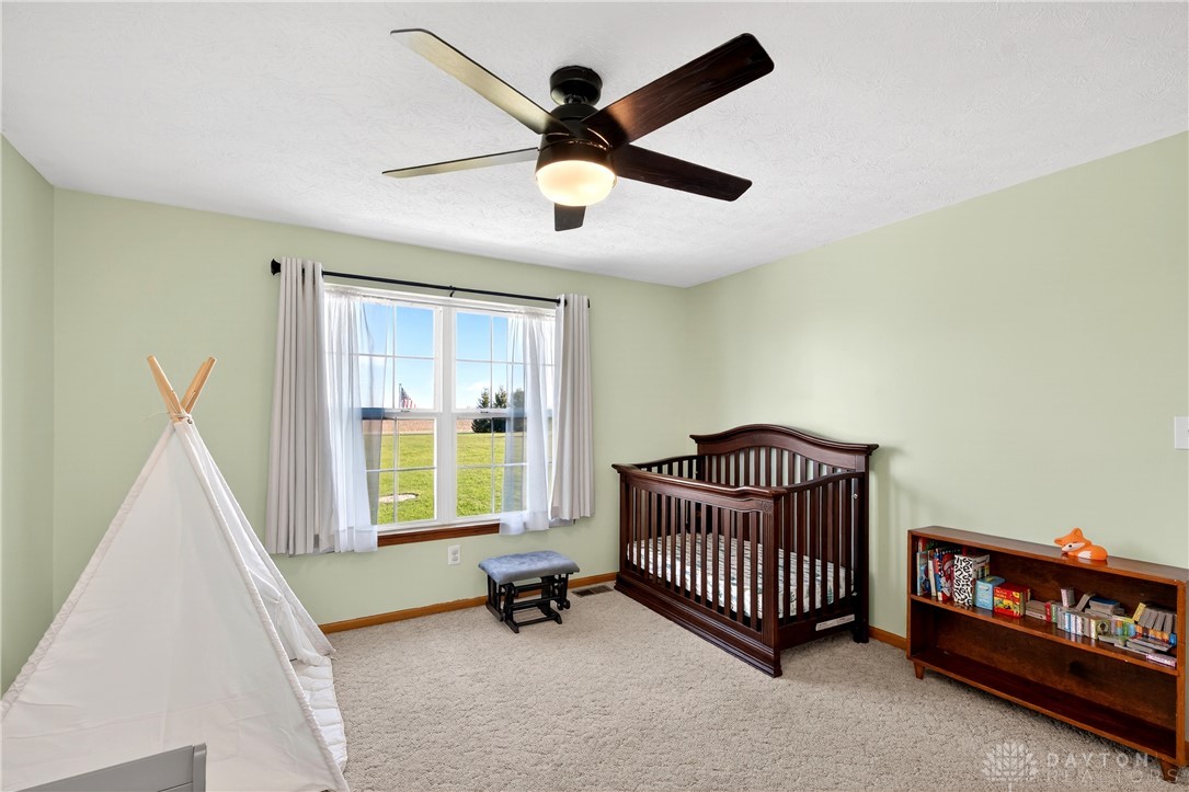 6560 Snyder Road Fletcher, OH 45326 - Photo 38 of 71 This cozy room offers a serene atmosphere with a large window and carpeted floors.