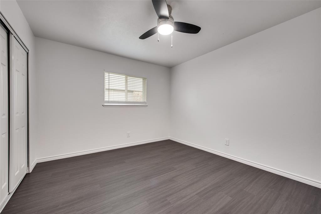 5412 Rice Drive The Colony, TX 75056 - Photo 11 of 17 wooden floor in an empty room with a window