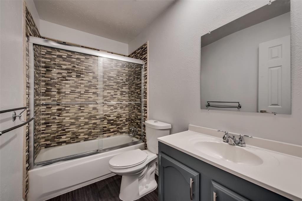 5412 Rice Drive The Colony, TX 75056 - Photo 13 of 17 a bathroom with a granite countertop toilet sink and mirror
