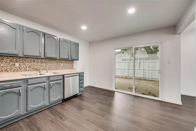 a kitchen with wooden cabinets and a sink