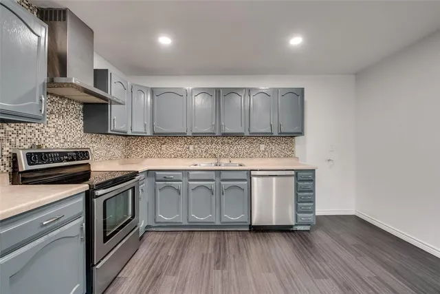 a kitchen with granite countertop stainless steel appliances and wooden cabinets