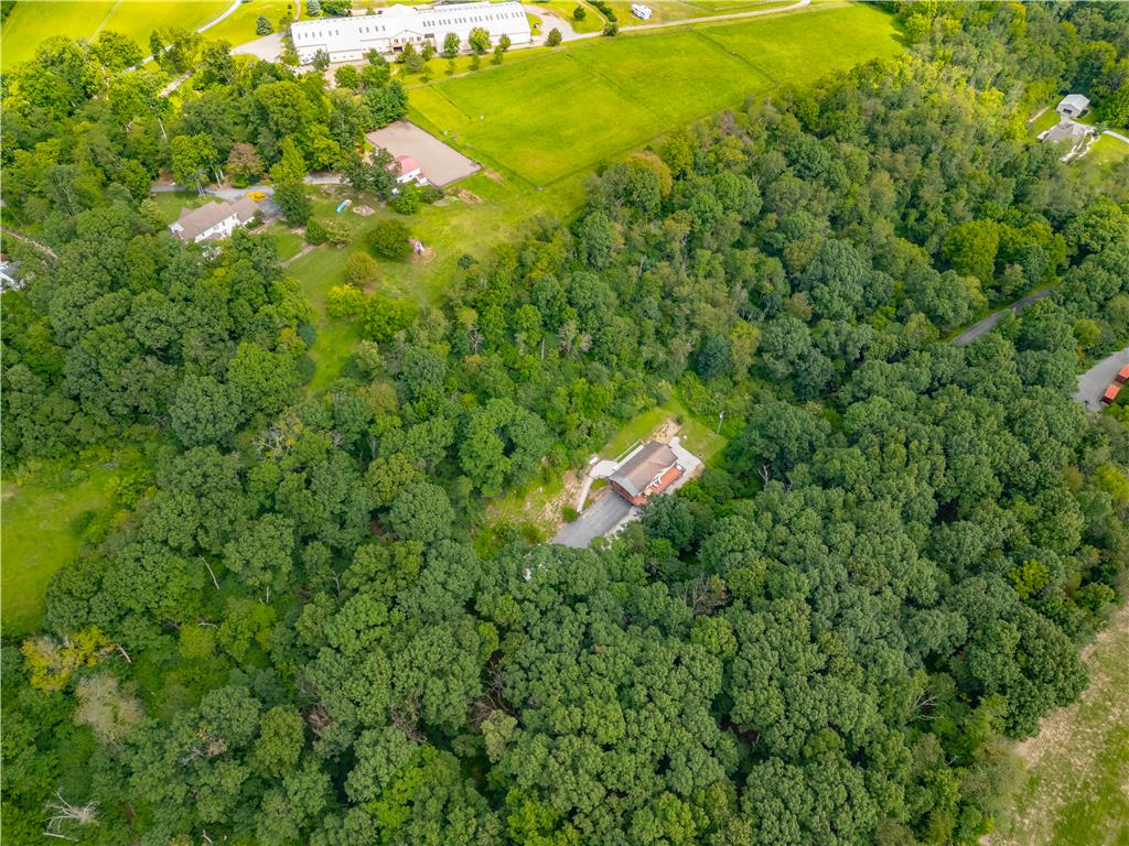 7353 Farrier Road Orefield, PA 18069 - Photo 66 of 74 Mature woodlands surround the secluded home sites and expansive green pastures in this countryside aerial view.