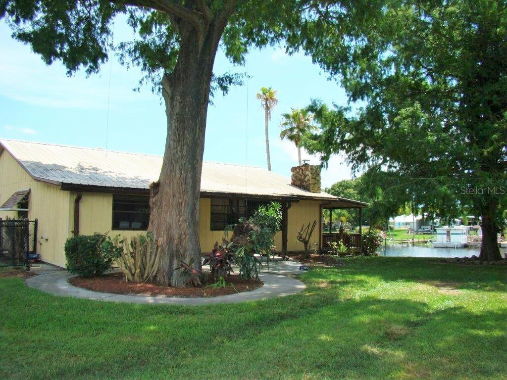 2902 Southeast 24th Street Okeechobee, FL 34974 - Photo 1 of 1 a front view of a house with garden