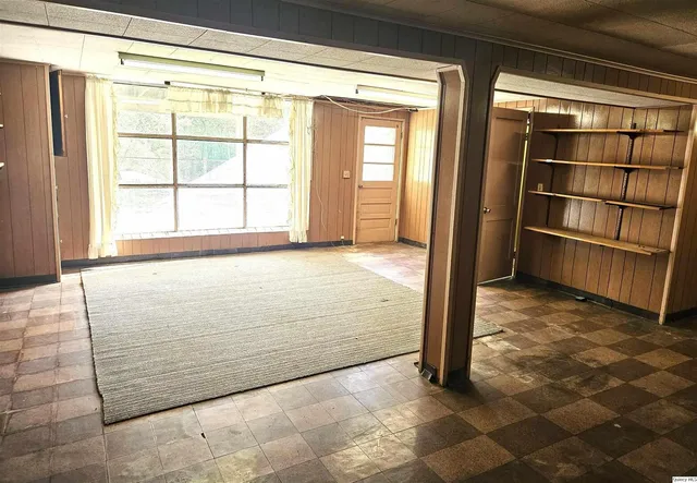 a view of empty room with fireplace and fan