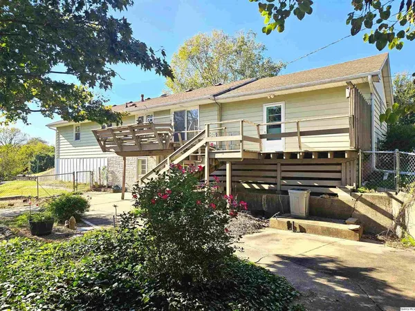 a view of a house with a backyard and sitting area